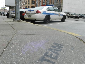 The Baltimore Ravens team emblem is featured on the sidewalk near Baltimore Police headquarters. (Photo by Kayla Faria)